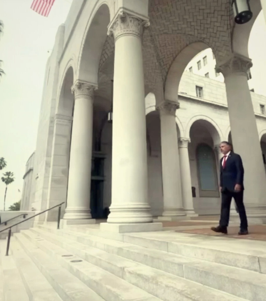 Tony Cárdenas walking out of a building